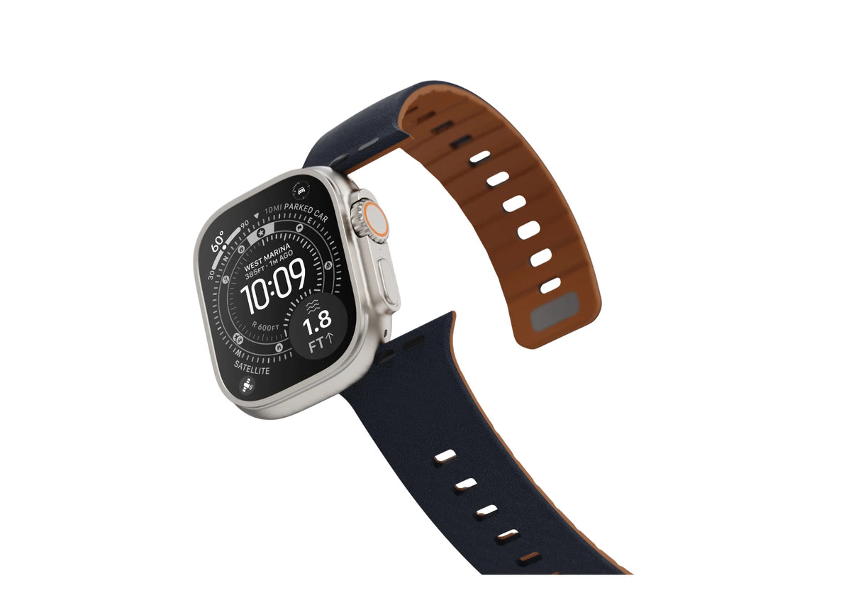 Angled view of Apple Watch Ultra with navy blue and brown magnetic silicone strap featuring a textured exterior, brown inner lining and adjustable fit