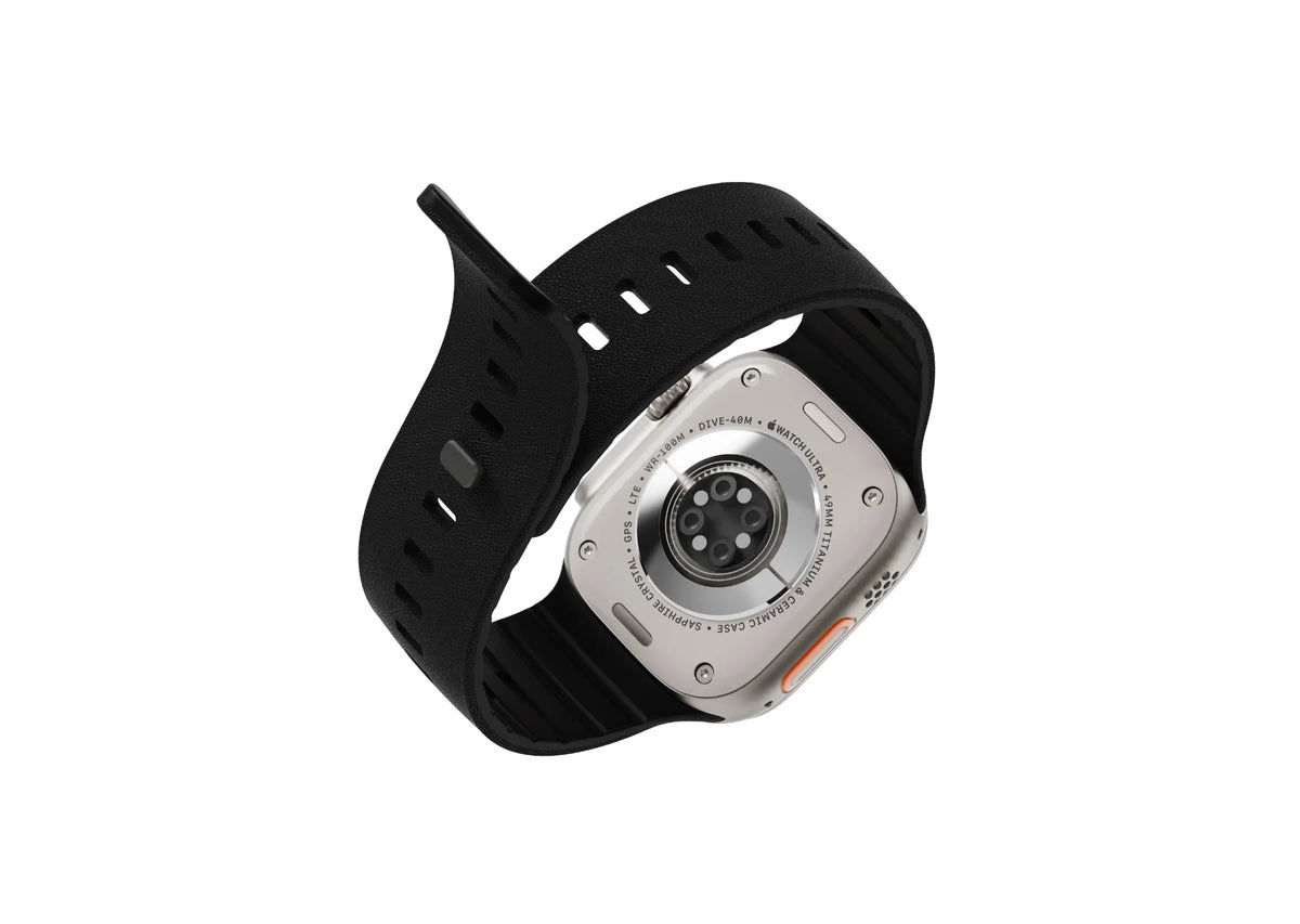 Apple Watch Ultra with a black magnetic silicone strap shown from the front at an angle